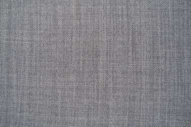 Gri arka plan kumaş dokusu. Yünlü bir kumaş parçası düzgünce yüzeye serilmiş. Dokuma ve tekstil dokusu. Kumaş ya da mutfak ihtiyaçları için, masa örtüsü ya da perdeler, yakın çekim. Çizgi.