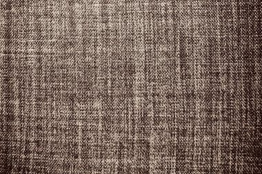 kahverengi arka plan kumaş dokusu. Yünlü bir kumaş parçası düzgünce yüzeye serilmiş. Dokuma ve tekstil dokusu. Kumaş ya da mutfak ihtiyaçları için, masa örtüsü ya da perdeler, yakın çekim. Çizgi.