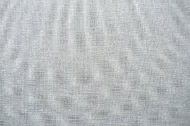 Gri arka plan kumaş dokusu. Yünlü bir kumaş parçası düzgünce yüzeye serilmiş. Dokuma ve tekstil dokusu. Kumaş ya da mutfak ihtiyaçları için, masa örtüsü ya da perdeler, yakın çekim. Çizgi.