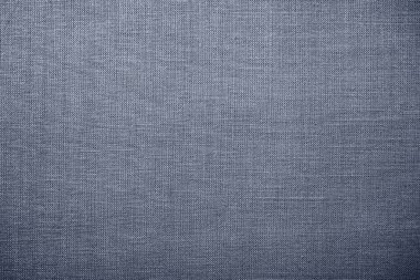 Gri arka plan kumaş dokusu. Yünlü bir kumaş parçası düzgünce yüzeye serilmiş. Dokuma ve tekstil dokusu. Kumaş ya da mutfak ihtiyaçları için, masa örtüsü ya da perdeler, yakın çekim. Çizgi.