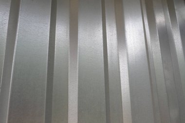aluminum chrome metal profiled sheet with vertical stripes. metallic gray.