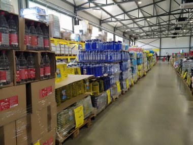 discount store chain MERE, Ruma, Serbia, April 15, 2022. Food and household goods at low prices in a warehouse type store. Food and drink are arranged on shelve. Boxes on pallets. Yellow price tags. clipart