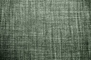 yeşil arka plan kumaş dokusu. Yünlü bir kumaş parçası düzgünce yüzeye serilmiş. Dokuma ve tekstil dokusu. Kumaş ya da mutfak ihtiyaçları için, masa örtüsü ya da perdeler, yakın çekim. Çizgi.