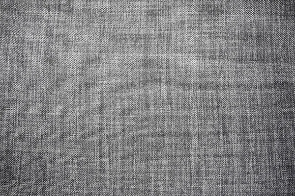 Gri arka plan kumaş dokusu. Yünlü bir kumaş parçası düzgünce yüzeye serilmiş. Dokuma ve tekstil dokusu. Kumaş ya da mutfak ihtiyaçları için, masa örtüsü ya da perdeler, yakın çekim. Çizgi.