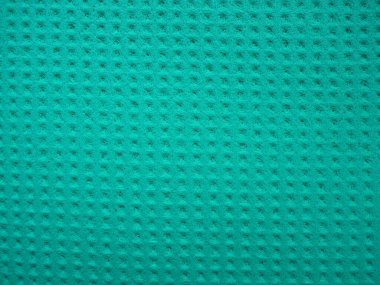 Sponge fibers sponge texture pattern surface close-up green background.