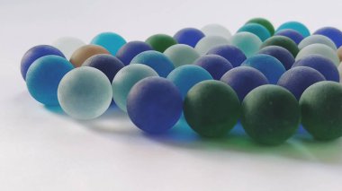 Oyun kumandaları ya da beyaz arka plana saçılmış renkli cam toplar. arka ışıklandırma.