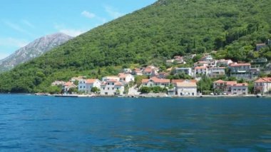 Boka Kotor Adriatic Sea, Verige Strait Kamenari Lepetane Ferry Line Trajekt. Houses on the shore, cars and people. Tourism and business in Montenegro. Maritime transport coastal. August 16 2022.