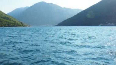 Boka Kotor Adriatic Sea, Verige Strait Kamenari Lepetane Ferry Line Trajekt. Strait between two mountains. Glare and rays of the sun. Tourism and business in Montenegro Maritime August 16 2022