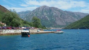 Boka Kotor Adriatic Sea, Verige Strait Kamenari Lepetane Ferry Line Trajekt. Houses on the shore, cars and people. Tourism and business in Montenegro. Maritime transport coastal. August 16 2022.