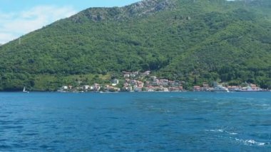 Boka Kotor Adriatic Sea, Verige Strait Kamenari Lepetane Ferry Line Trajekt. Houses on the shore, cars and people. Tourism and business in Montenegro. Maritime transport coastal. August 16 2022.
