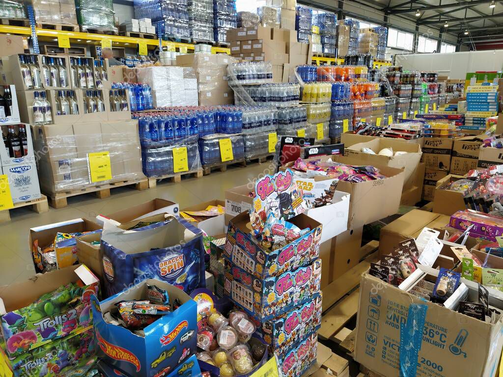 Discount store chain MERE, Ruma, Serbia, April 15, 2022. Food and household goods at low prices in a warehouse type store. Food and drink are arranged on shelve. Boxes on pallets. Yellow price tags.