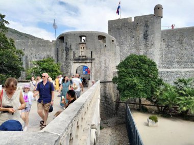 Pile Gate Dubrovnik Hırvatistan 14 Ağustos 2022 Erkekler ve kadınlar taş köprü boyunca Eski Şehir 'in kapısına yürüyorlar. Turist kalabalığı. Yoğun giriş. Eski şehrin ana girişi, işlek Yığın Kapısı