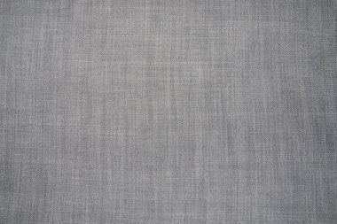 Gri arka plan kumaş dokusu. Yünlü bir kumaş parçası düzgünce yüzeye serilmiş. Dokuma ve tekstil dokusu. Kumaş ya da mutfak ihtiyaçları için, masa örtüsü ya da perdeler, yakın çekim. Çizgi.