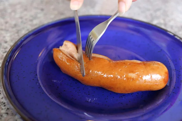 Pork sausages on blue dish — Stock Photo, Image