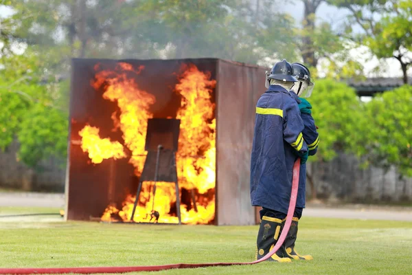 Firefighter fighting for fire attack training — Stock Photo, Image