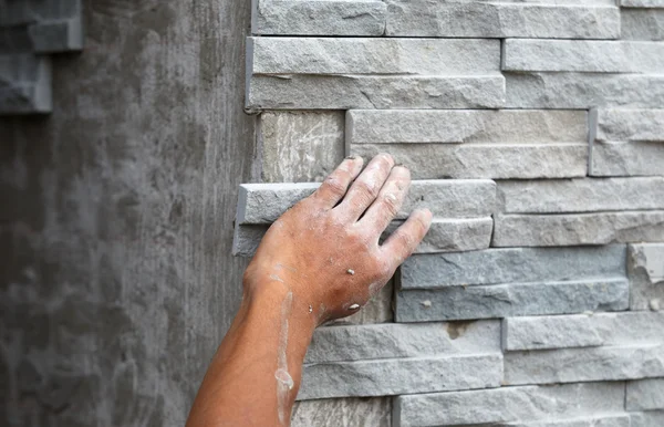 Worker install stone wall surface with cement for house — Stock Photo, Image