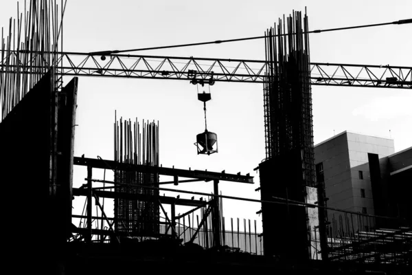 Construction site with cranes on silhouette background — Stock Photo, Image