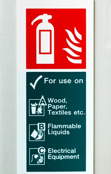 Symbol of fire extinguisher isolated on white wall — Stock Photo, Image