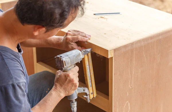 Carpenter used air-gun for make new furniture — Stock Photo, Image