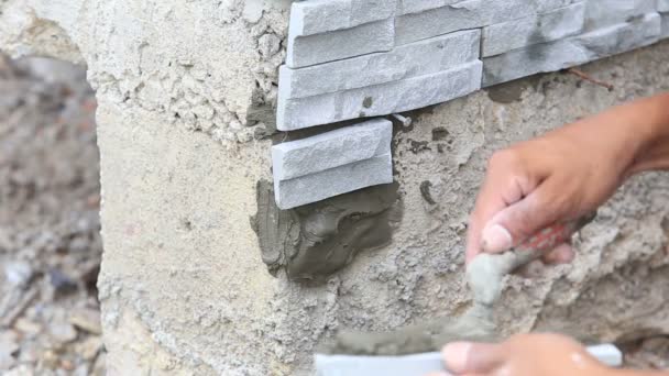 Trabajador instalar superficie de la pared de piedra — Vídeos de Stock