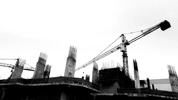 Construction site with cranes on silhouette background — Stock Photo, Image