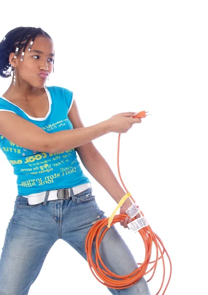 Mladá dívka si hraje s napájecího kabelu — Stock fotografie