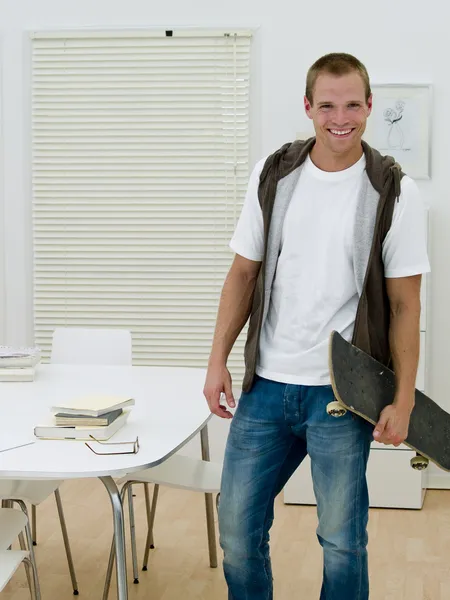 Young man with a skateboard — Stock Photo, Image