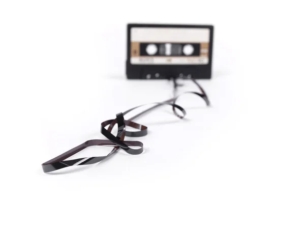 Retro cassette with loose tape over a white background — Stock Photo, Image