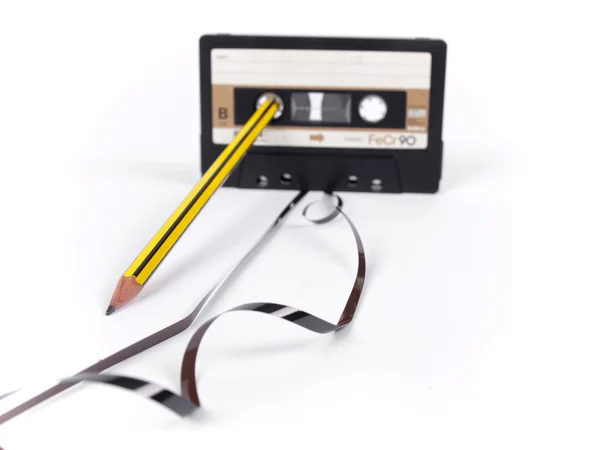 Retro cassette with loose tape over a white background — Stock Photo, Image