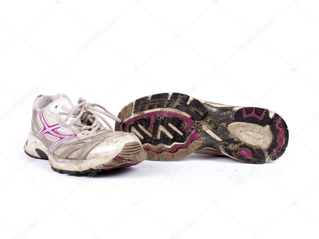 Very old dirty pair of running shoes over a white background — Photo