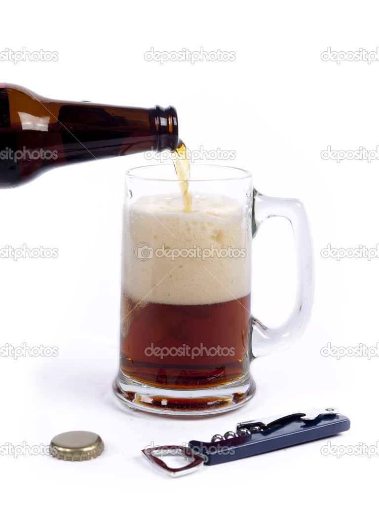 Pouring dark bock beer from the bottle into the glass