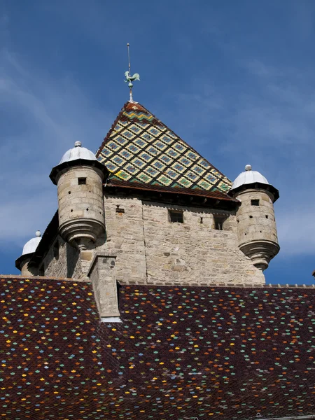 Colorful rooftop tiles on a castle in a small village in France — Stock Photo, Image