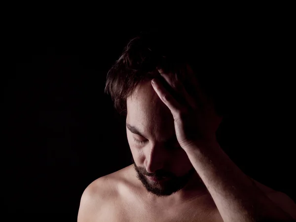 Low key image of a depressed bearded man — Stock Photo, Image