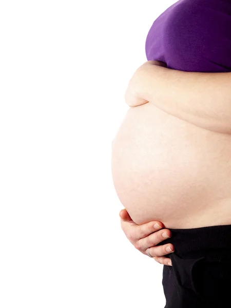 Pregnant young woman holding her naked belly — Stock Photo, Image