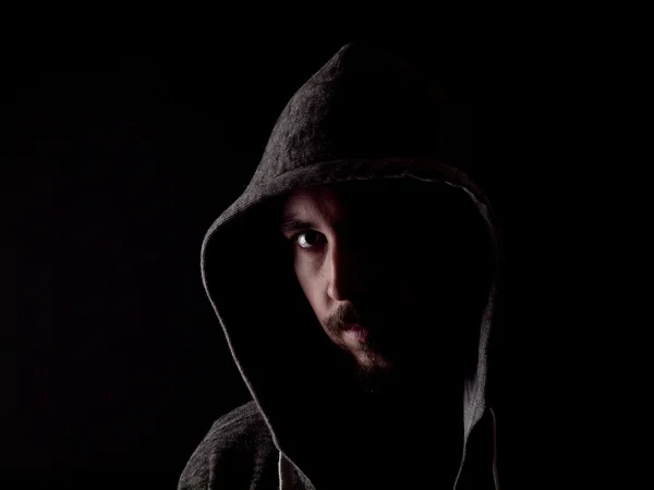 Low key image of a bearded man with a hoody — Stock Photo, Image