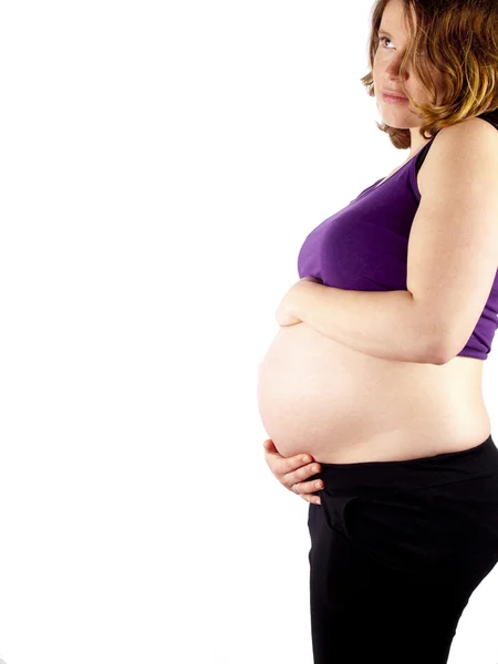 Pregnant young woman holding her naked belly — Stock Photo, Image