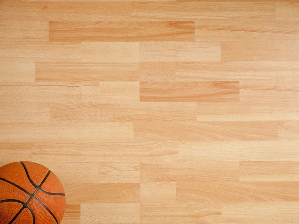 Una palla arancione ufficiale su un campo da basket in legno duro — Foto Stock