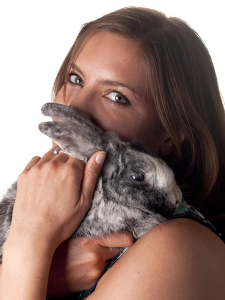 Smiling beautiful brunette holding and petting her bunny — Stock Photo, Image