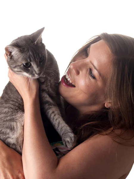 Smiling beautiful brunette holding and petting her cute grey cat — Stock Photo, Image