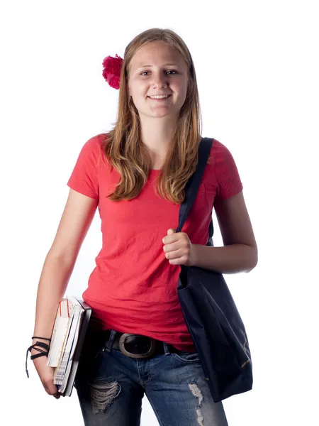 Junge Studentin trägt Bücher über weißem Hintergrund — Stockfoto