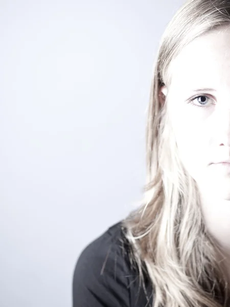 High key image of a young teenage girl looking sad or depressed — Stock Photo, Image