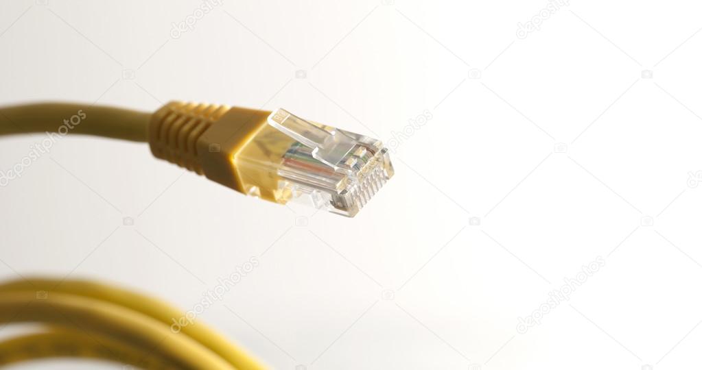 Yellow network cable with RJ45 connector on white background
