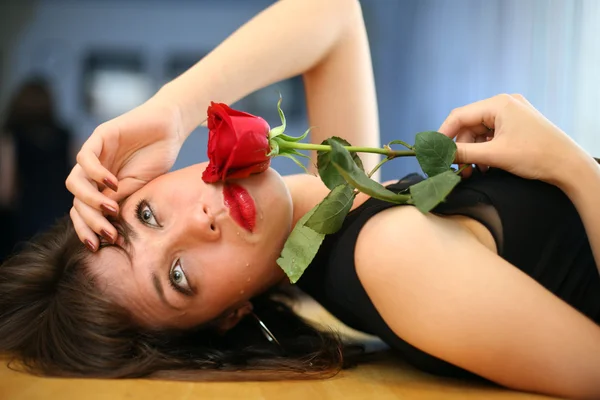 Jeune femme solitaire à la rose rouge, pleurant — Photo