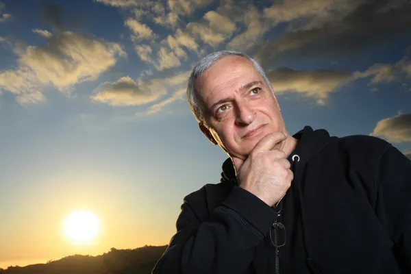 Mature man outdoors, thinking — Stock Photo, Image