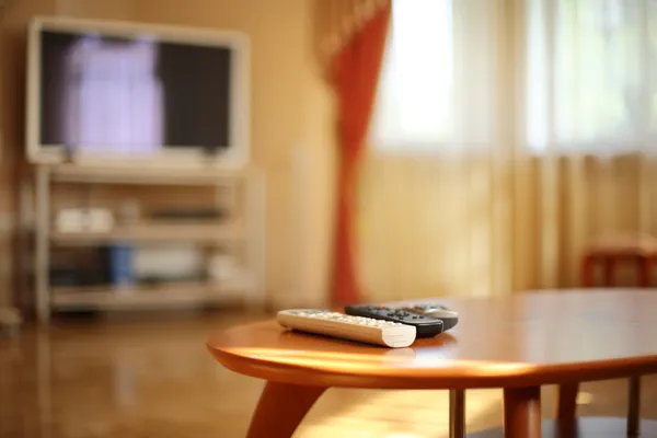 TV remotes in stylish interior — Stock Photo, Image