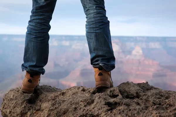 Pieds masculins debout sur le bord d'une falaise — Photo