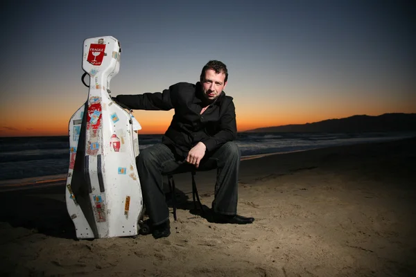 Musician with travel cello or guitar case. — Stock Photo, Image
