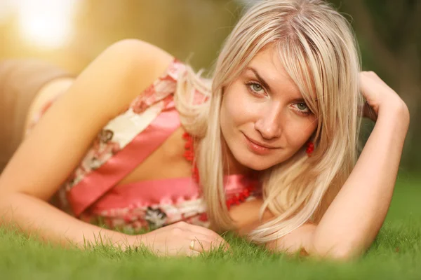 Woman lying on green lawn — Stock Photo, Image