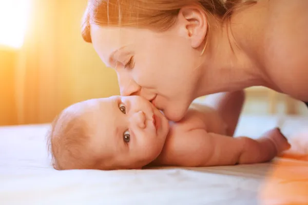 Mother kissing baby — Stock Photo, Image