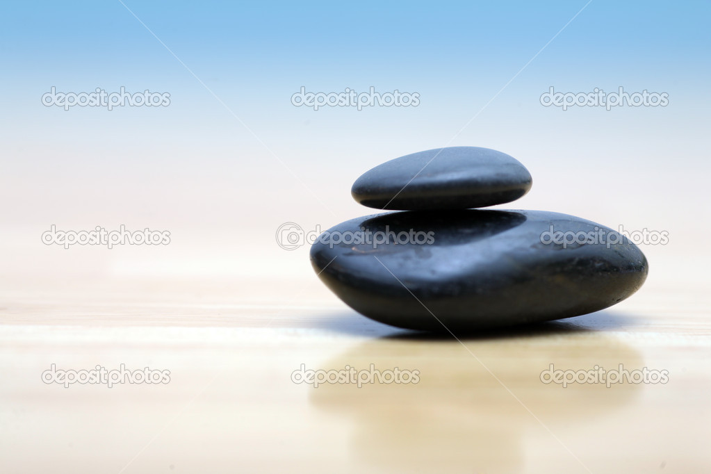 Zen stones on wooden surface
